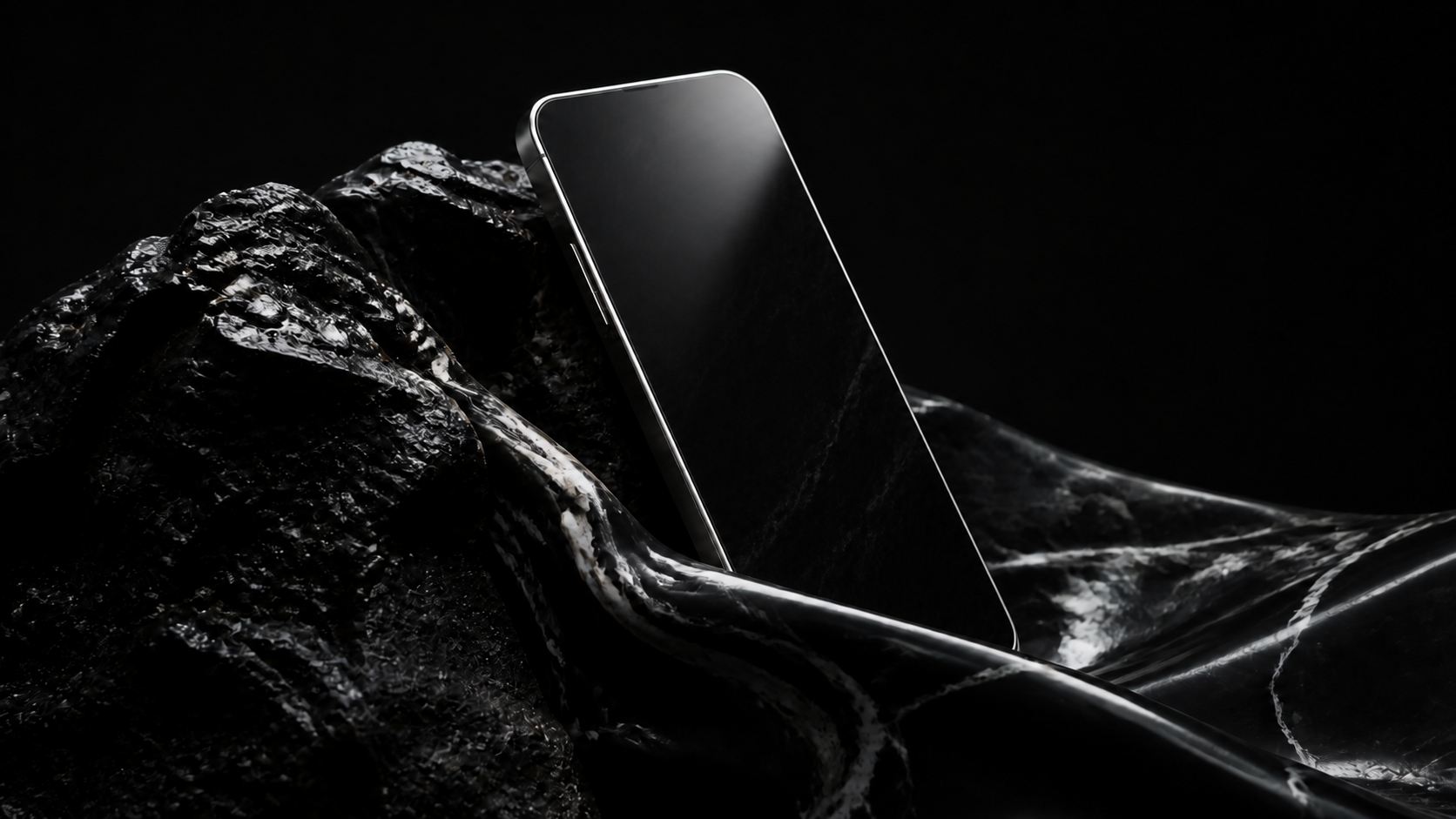 A black smartphone emerging from sculptural dark rock